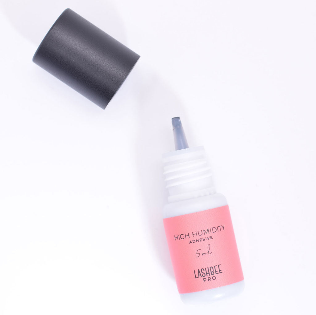 LashBeePro High Humidity Adhesive for eyelash extensions - front of the pink bottle with black cap removed to show bottle nozzle